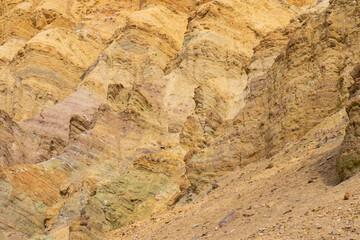 Vivid golden canyon walls caused by erosion in Death Valley National Park