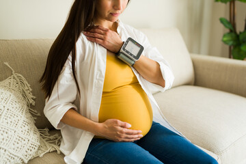 Expecting mother with health problems checking her high blood pressure