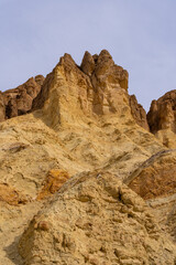 Vivid golden canyon walls caused by erosion in Death Valley National Park