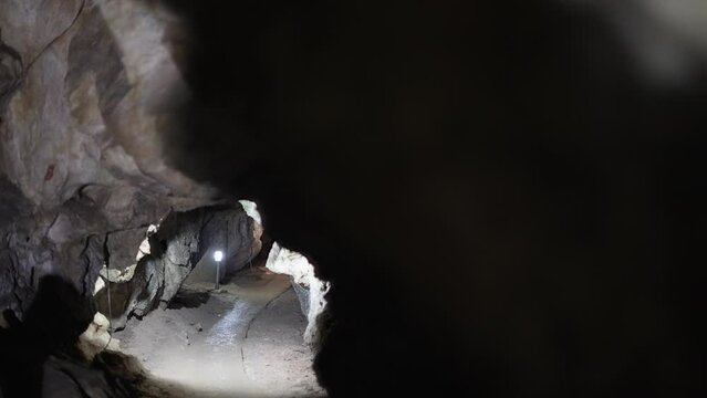 Inside of a beautiful colourful cave. Flowstones, stalactites and stalagmites lighted in different vivid colours.