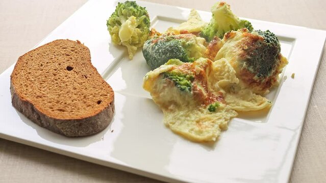 Indulge in aroma of delicious omelette and broccoli breakfast, elegantly served on table. Sizzling omelette tantalizes senses Dive into flavorful omelette and broccoli breakfast, perfect morning treat