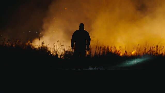 Firefighters estinguishing forest bushfire fire at night
