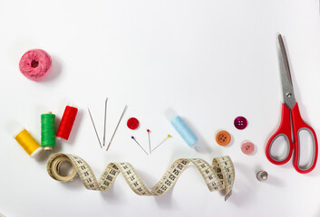Copyspace frame with different sewing accessories: scissors, threads, needles, tape measures, buttons, etc.
