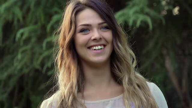 happy teenager winking with a piercing on the tongue