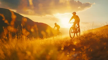 Foto op Aluminium Mountain Bikers Riding in the Highlands. Active Lifestyle concept. sommer, golden lights, sunrise, beautiful weather © Axel