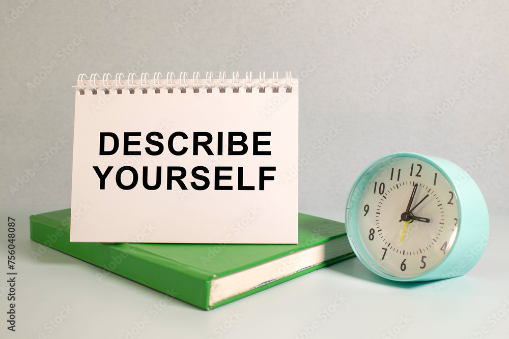 Aufkleber describe yourself text written on sticky on chart with keyboard and magnifier.