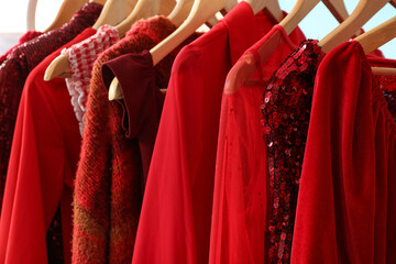 Rack with stylish clothes on blue background