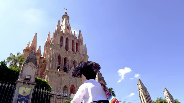 Giant puppet also known as mojigangas dancing in front of the Parroquia of San Miguel Arc&aacute;ngel in plaza Allende at the morning, city of San Miguel De Allende, Mexico.  Magic town