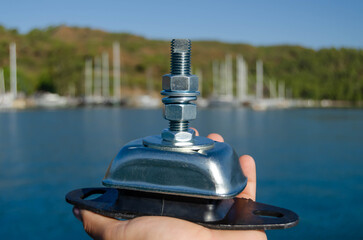 Obraz premium A new marine engine mount for a sailing yacht on the marina background.