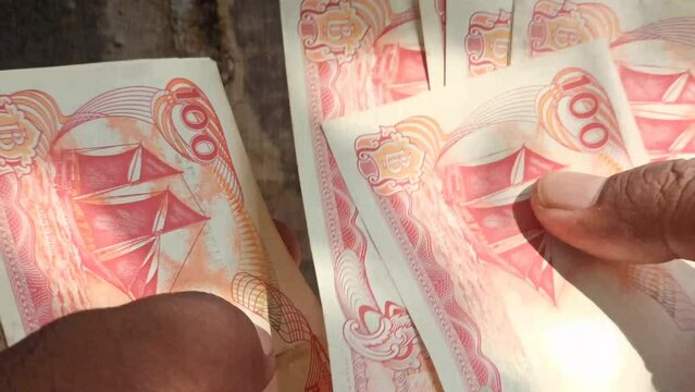 counting rupiah money by hand