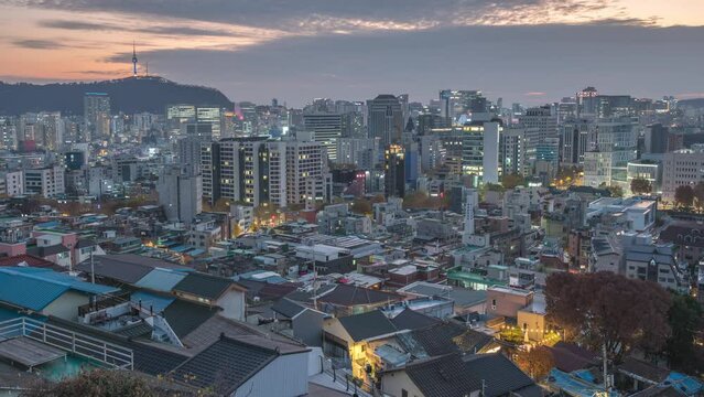 Seoul South Korea time lapse city skyline day to night sunset view from Naksan Park in autumn