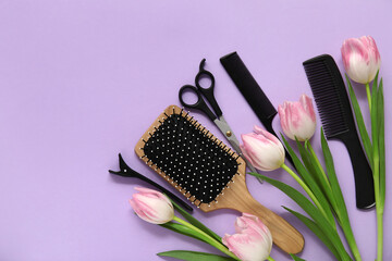 Hairdresser's tools with beautiful tulips on lilac background