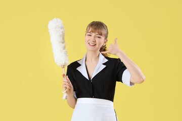 Young chambermaid with pp-duster showing 