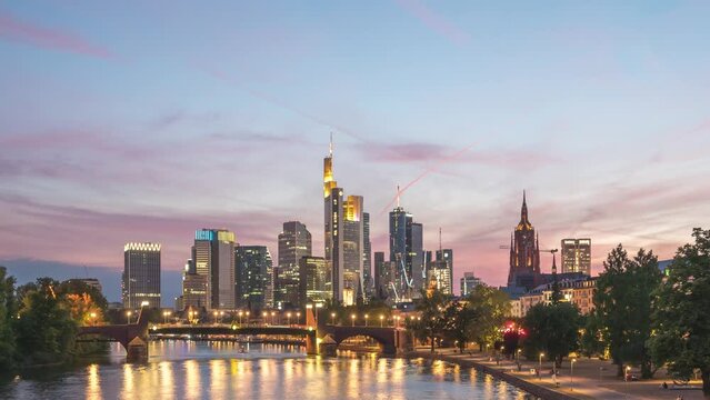 Frankfurt Germany time lapse, day to night sunset city skyline at Main River and business skyscraper