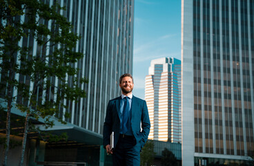 Fototapeta premium Businessman with success business. Outdoors portrait male model in suit.