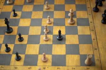 Playing chess in tournament. Chess pieces on board. Sports competition at school. Gaming prowess.
