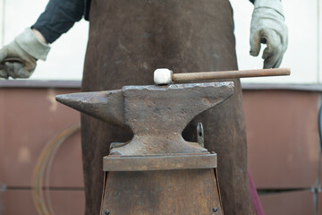Blacksmith and Anvil. Hammer blow. Anvil on farm. - obrazy, fototapety, plakaty