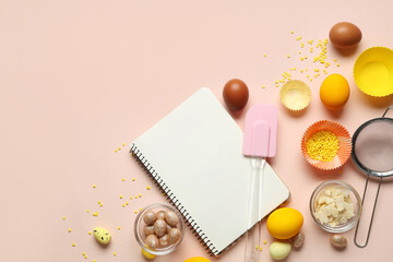 Blank notepad for recipes with Easter eggs and kitchen tools on beige background