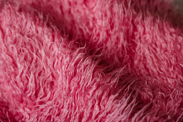 Plush purple throw blanket stored in an elegant floral basket