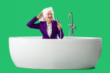 Morning of funny businesswoman sitting in bathtub on green background