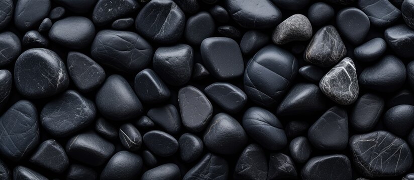 Closeup shot of a stack of dark stones resembling automotive tires, with a pattern similar to electric blue beans. The natural foods look like metal auto parts, giving off a mysterious vibe