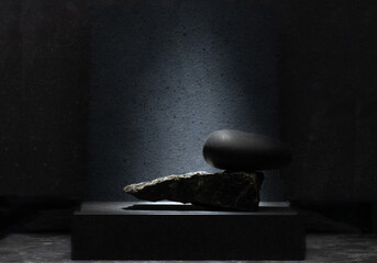 composition of black stones on a dark background for the podium