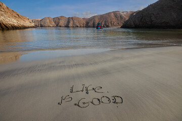 Life Is Good writing on a sandy beach Arequipa Peru