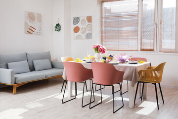 Interior of stylish dining room with Easter table setting
