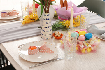 Festive Easter table setting with painted eggs and flowers