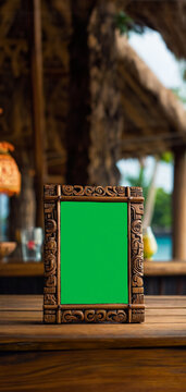A mobile friendly vertical image of a table topper or table tent with a carved wood frame menu or cocktail list, chroma key green screen. A tiki  frame in the foreground a tiki bar in the background