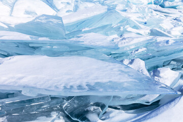 Obraz premium Winter cold natural background with pile of ice floes on frozen sea. Blue snowy flat ice floe can serve as podium or pedestal for advertising cosmetics products or food goods. Natural winter backdrop