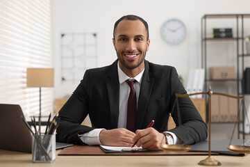 Portrait of smiling lawyer at table in office