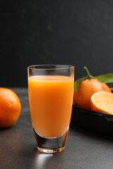 Delicious tangerine liqueur and fresh fruits on grey table