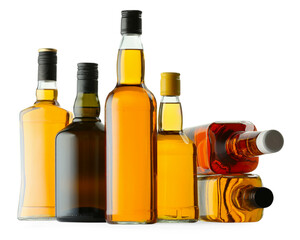 Different sorts of whiskey in glass bottles isolated on white