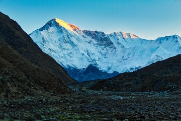 Mount Cho Oyu, 6th highest mountain in the world at 8188 meters, is lit up by the early morning sun in this tranquil view from the Gokyo valley 