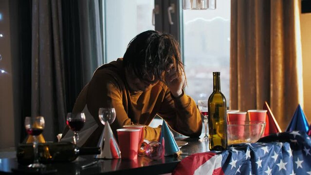 A young guy is trying to wake up and cope with a hangover