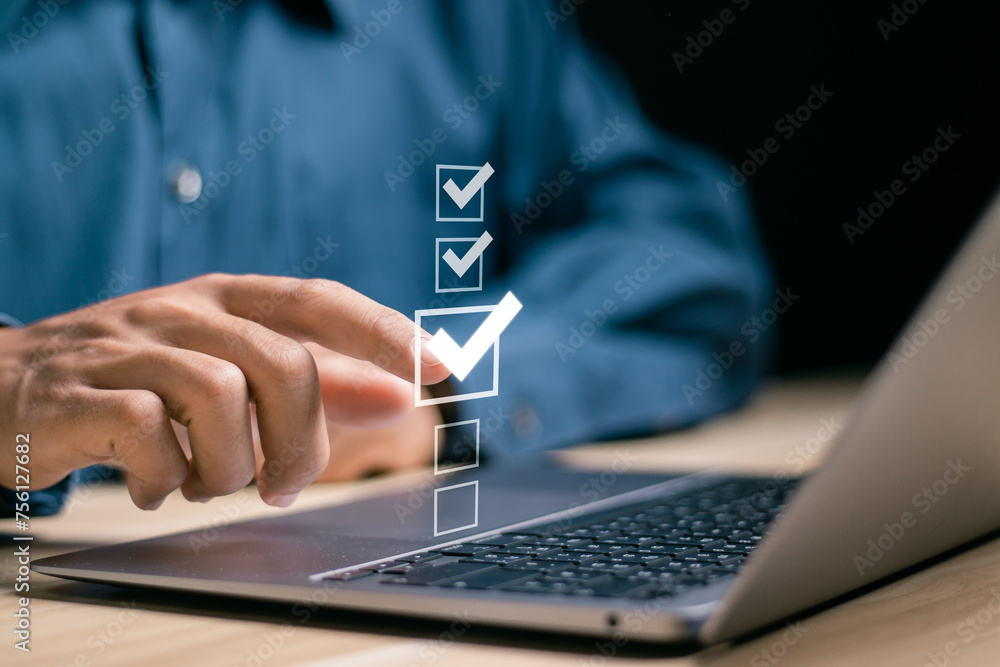 Poster checklist concept. businessman using laptop to checking mark on checkboxes.
