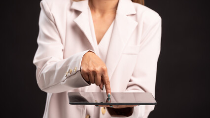 Businesswoman holding Digital tablet computer with isolated screen in male hands, Networking, digital app in black background With copy space