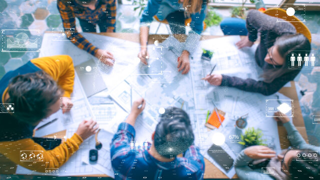 Multi-disciplinary team engaging with digital construction interface, innovation at work.