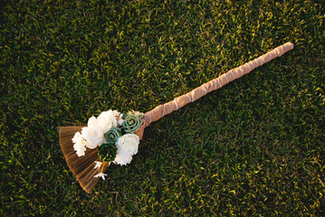 Beautiful traditional broom, Jumping the broom (or jumping the besom) is a phrase and custom relating to a wedding ceremony in which the couple jumps over a broom.