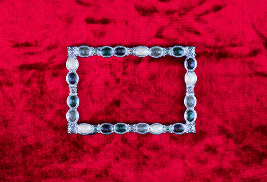 silver jewelry frame on red background
