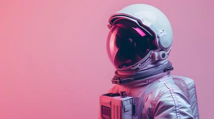 Tuinposter A man in a helmet and space suit stands in front of a pink background © Nadtochiy