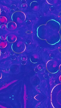Vertical video. Abstract background. Colorful liquid mix. Paint kaleidoscope. Neon pink blue shimmering ink blend bubbles symmetrical motion in creative ornament art.