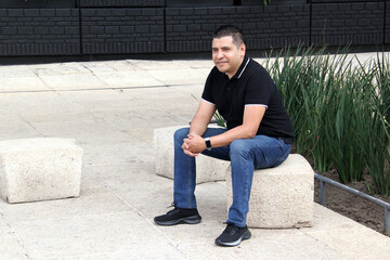 Latin adult man wears black tennis shoes that serve to protect the foot from friction with a...