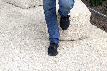 Latin adult man wears black tennis shoes that serve to protect the foot from friction with a...