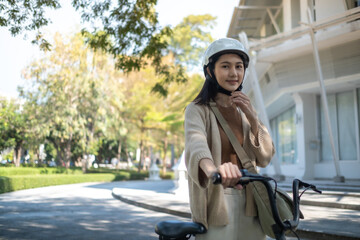 Obraz premium bicyclist Caucasian woman in casual clothes and helmet walking chill in the park city
