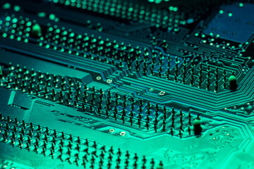 green computer motherboard. extreme closeup of electrical connections.