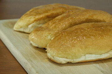 Butter bread bun on wooden board.