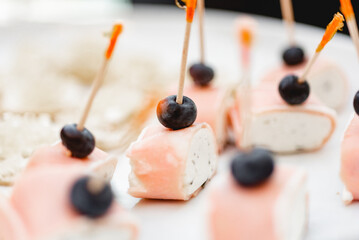 Close up of gourmet snack made of salmon , goat cheese and blueberry  - obrazy, fototapety, plakaty