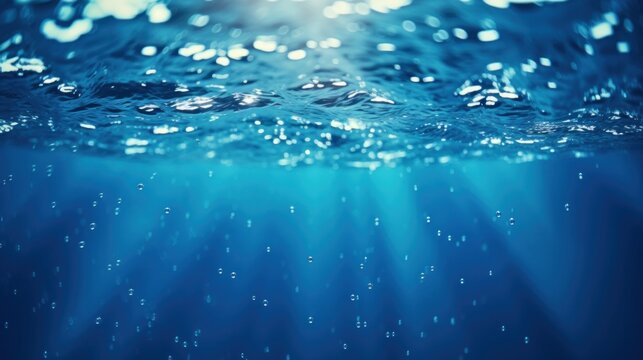 Blue waves and bubbles underwater Underwater blue ocean background in the sea Underwater view of the sea surface
